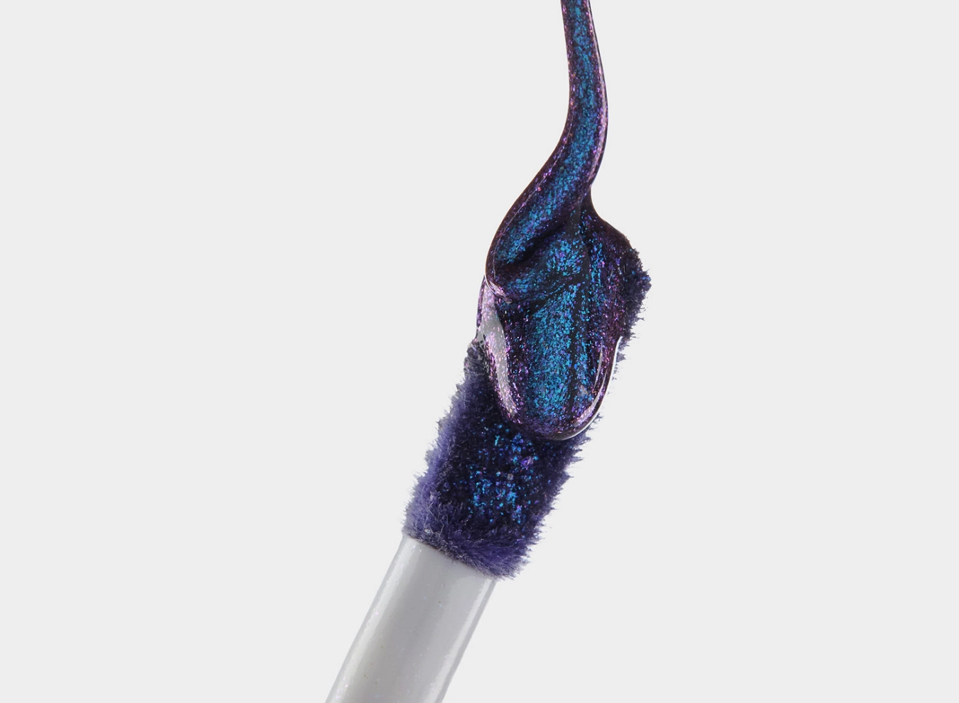 Blue glitter lip wand against a white background